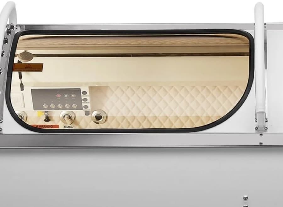 Through the chamber's wide viewing window: the quilted interior where you rest